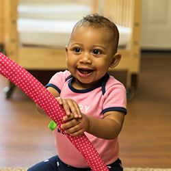 baby in the infant classroom smiling