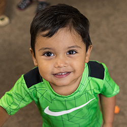 Toddler boy looking up and smiling