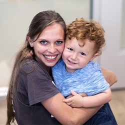 teacher hugging two year old boy