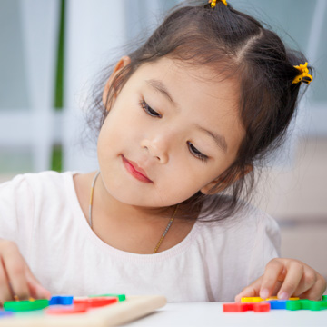 niña jugando con un rompecabezas